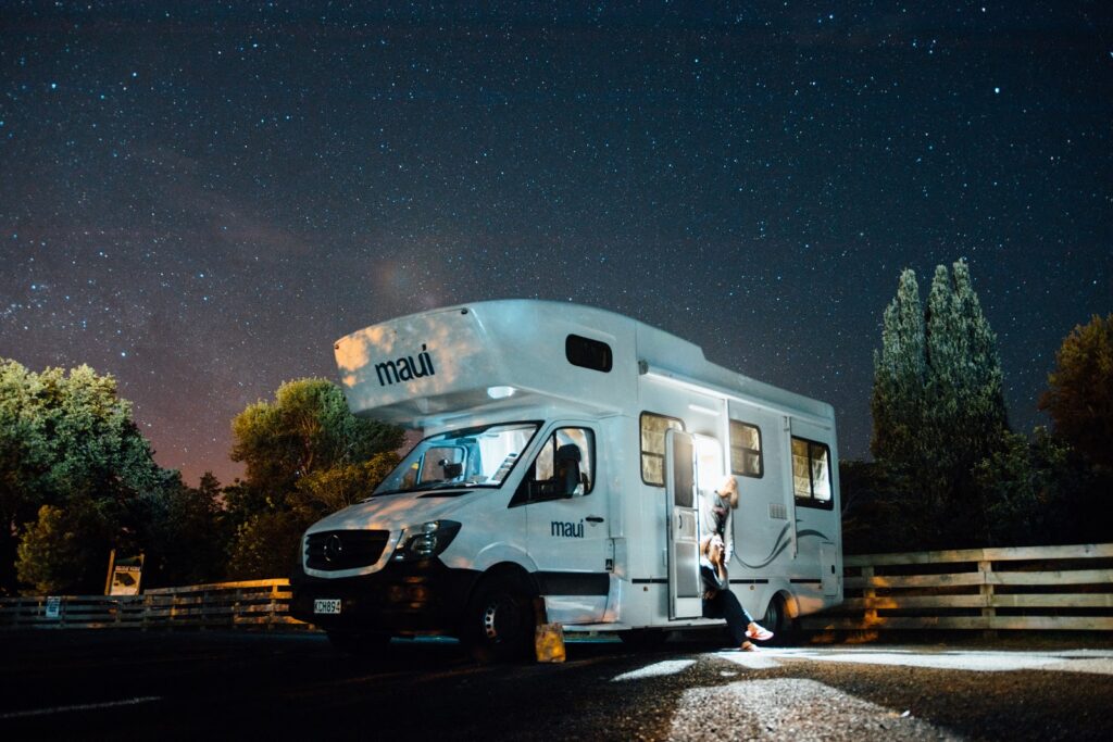 An RV beneath the stunning night sky