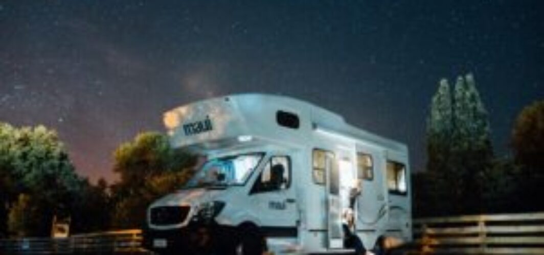 An RV beneath the stunning night sky