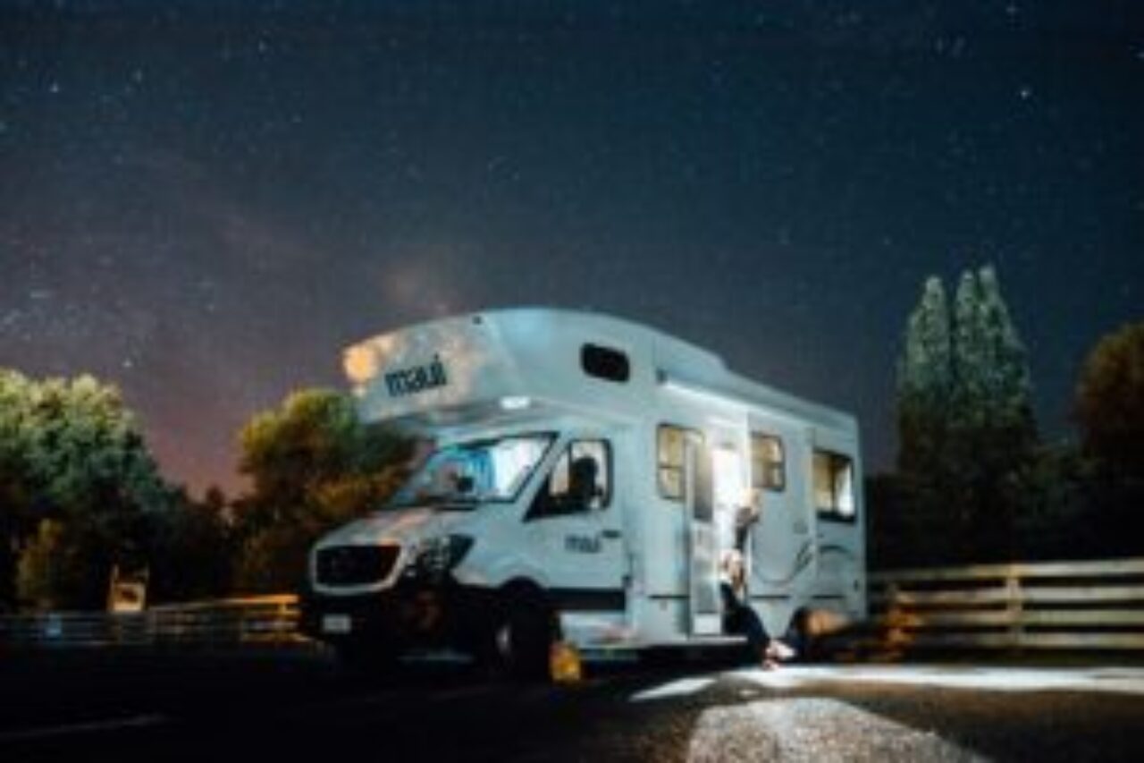 An RV beneath the stunning night sky