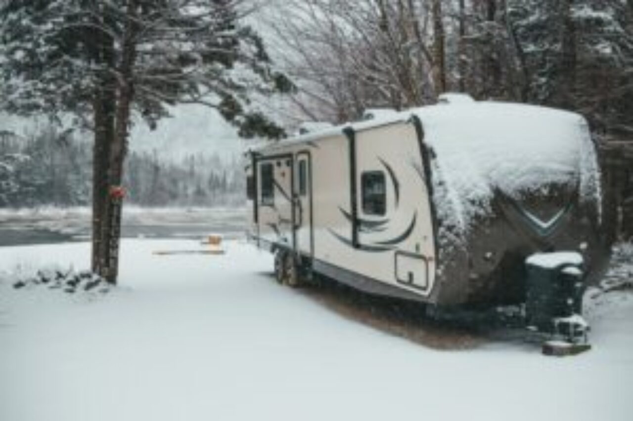 Winter RV camping adventure. An RV nestled in a snowy landscape. Ways to Insulate Your RV